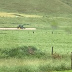 Farmer races to move his balage from a flooding paddock.